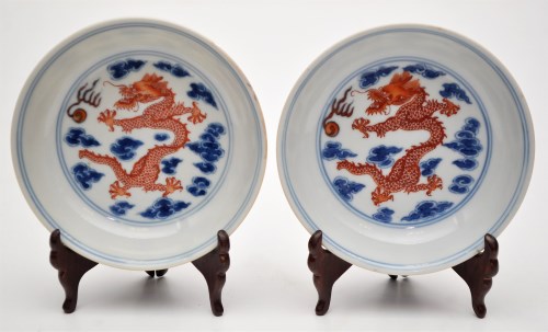 Lot 523 - Pair of blue and white and iron red saucer...