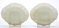 Lot 585 - Pair of celadon jade quatrefoil wine cup...