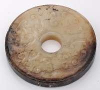 Lot 593 - Small bi-coloured jade disc, bi, quartered...