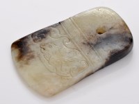 Lot 595 - Brown veined celadon jade axehead pendant, the...