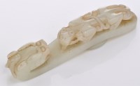 Lot 597 - Pale celadon jade 'chilong' belt hook, the...