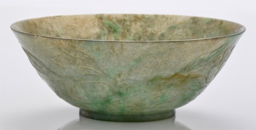 Lot 602 - Mottled green jadeite bowl, the sides curving...