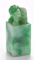 Lot 632 - Variegated jadeite 'beast' seal, its head...