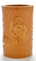 Lot 697 - Ochre glaze carved bisque brush pot, bitong,...