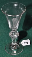 Lot 779 - A baluster wine glass, the bell bowl raised on...