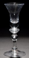 Lot 790 - A baluster wine glass, the waisted bell bowl...