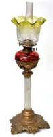 Lot 821 - 'Cranberry' glass oil lamp on giltmetal stand,...