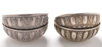 Lot 1161 - Four embossed white metal bowls, possibly...