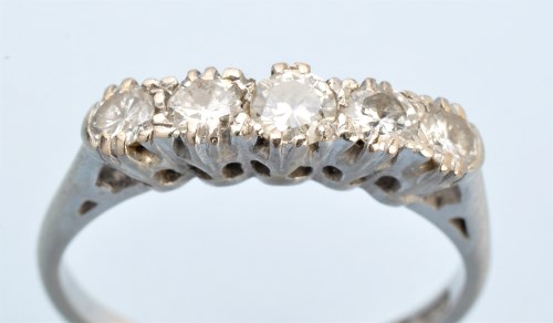Lot 1195 - A five stone diamond ring, the graduated...