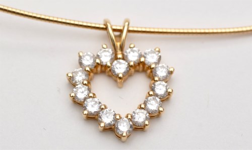 Lot 1196 - A diamond heart shaped pendant, the open heart...