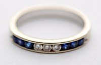 Lot 1197 - A sapphire and diamond half hoop eternity ring,...