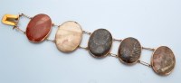 Lot 1200 - A hardstone and yellow metal bracelet, the...