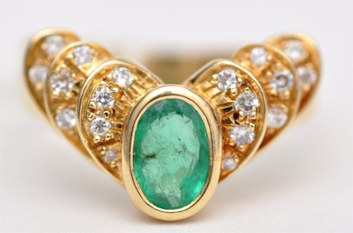 Lot 1202 - An emerald and diamond ring, the oval facet...