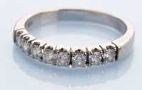 Lot 1205 - An eight stone diamond ring, the brilliant-cut...