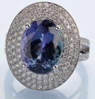 Lot 1210 - A tanzanite and diamond cluster ring, the...