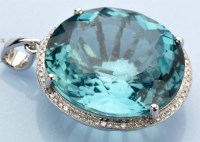 Lot 1211 - An aquamarine and diamond pendant, the oval...