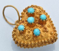 Lot 1219 - A turquoise and yellow metal heart shaped...