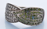 Lot 1222 - A green and white diamond dress ring, in...