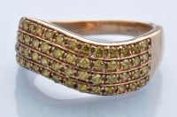 Lot 1223 - A yellow diamond ring, in four rows of wavy...