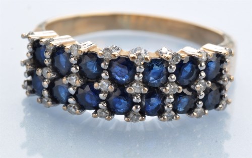 Lot 1224 - A sapphire and diamond ring, the seven pairs...