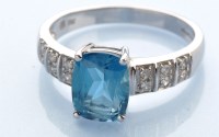 Lot 1228 - A blue topaz and diamond ring, the oval...
