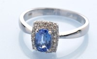 Lot 1229 - A sapphire and diamond cluster ring, the oval...