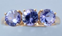 Lot 1230 - A three stone tanzanite ring, each of the...