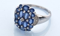 Lot 1243 - A sapphire and diamond ring, the oval and...