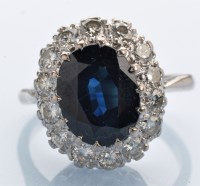 Lot 1247 - A sapphire and diamond cluster ring, the oval...
