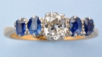 Lot 1262 - A diamond and sapphire ring, the central old...