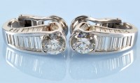 Lot 1265 - A pair of diamond earrings, each set with...