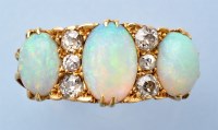 Lot 1271 - An opal and diamond ring, the three graduated...