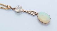 Lot 1273 - An opal and rock crystal pendant, the oval...