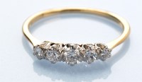 Lot 1280 - A five stone diamond ring, the graduated old...