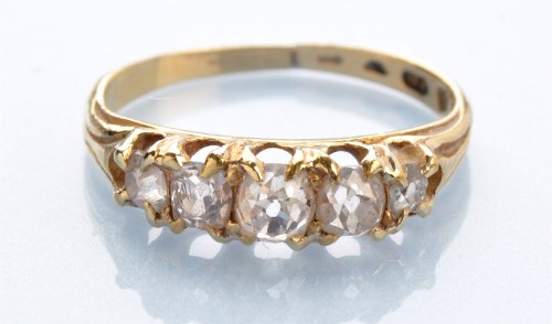 Lot 1281 - A five stone diamond ring, set with graduated...