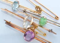 Lot 1286 - Five gem-set bar brooches, to include: a...