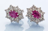 Lot 1289 - A pair of ruby and diamond cluster stud...