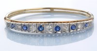 Lot 1296 - A sapphire and diamond bangle, the six...