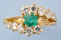Lot 1299 - An emerald and diamond ring, the circular...