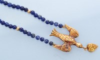Lot 1305 - A lapis lazuli and yellow metal necklace, the...