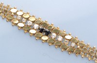 Lot 1307 - A blue and white sapphire bracelet, the yellow...