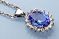 Lot 1308 - A tanzanite and diamond cluster pendant, the...