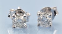 Lot 1314 - A pair of diamond stud earrings, the brilliant-...