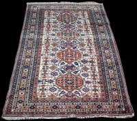 Lot 1343 - A Caucasian carpet, the white ground with four...