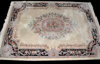 Lot 1363 - A 20th Century Chinese carpet, the ivory field...