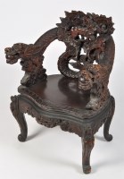 Lot 1442 - A Far Eastern carved hardwood solid seat...