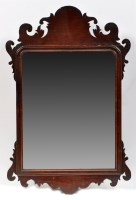 Lot 1469 - A Georgian mahogany wall mirror with carved...