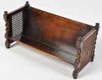 Lot 1477 - An early 20th Century stained wood book trough,...