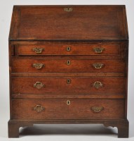 Lot 1490 - A George III oak bureau with a rectangular...