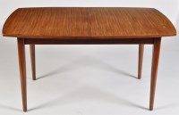 Lot 16 - A teak draw leaf dining table, raised on...